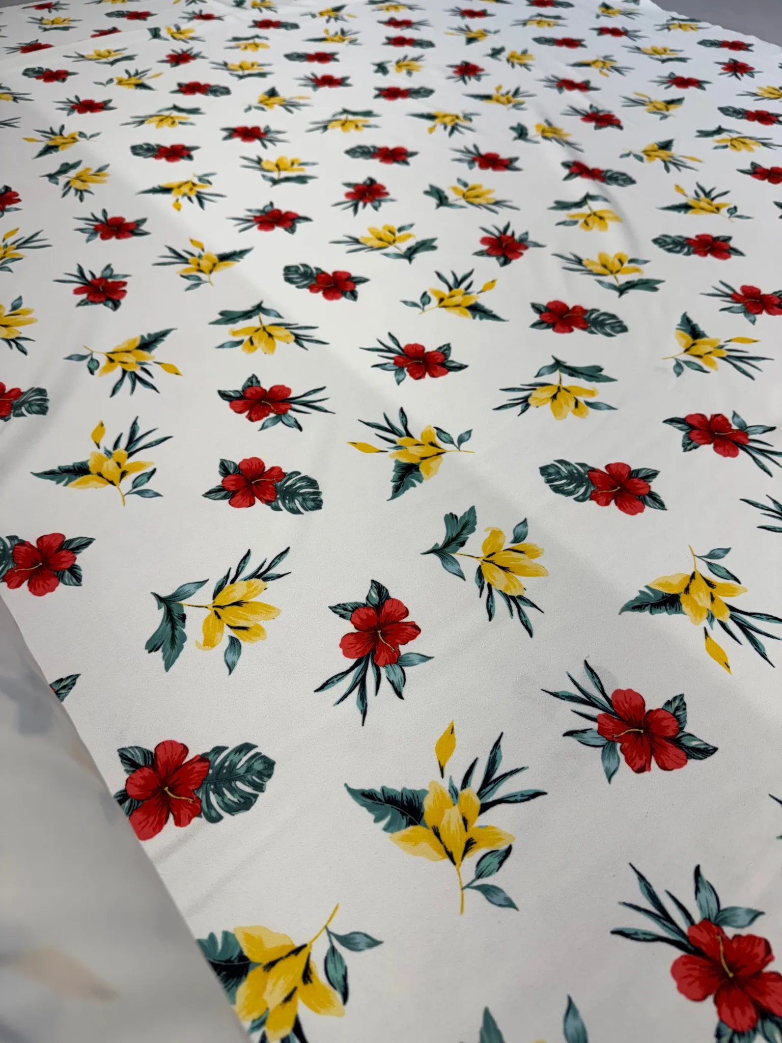 Woven polyester fabric in red and yellow floral print