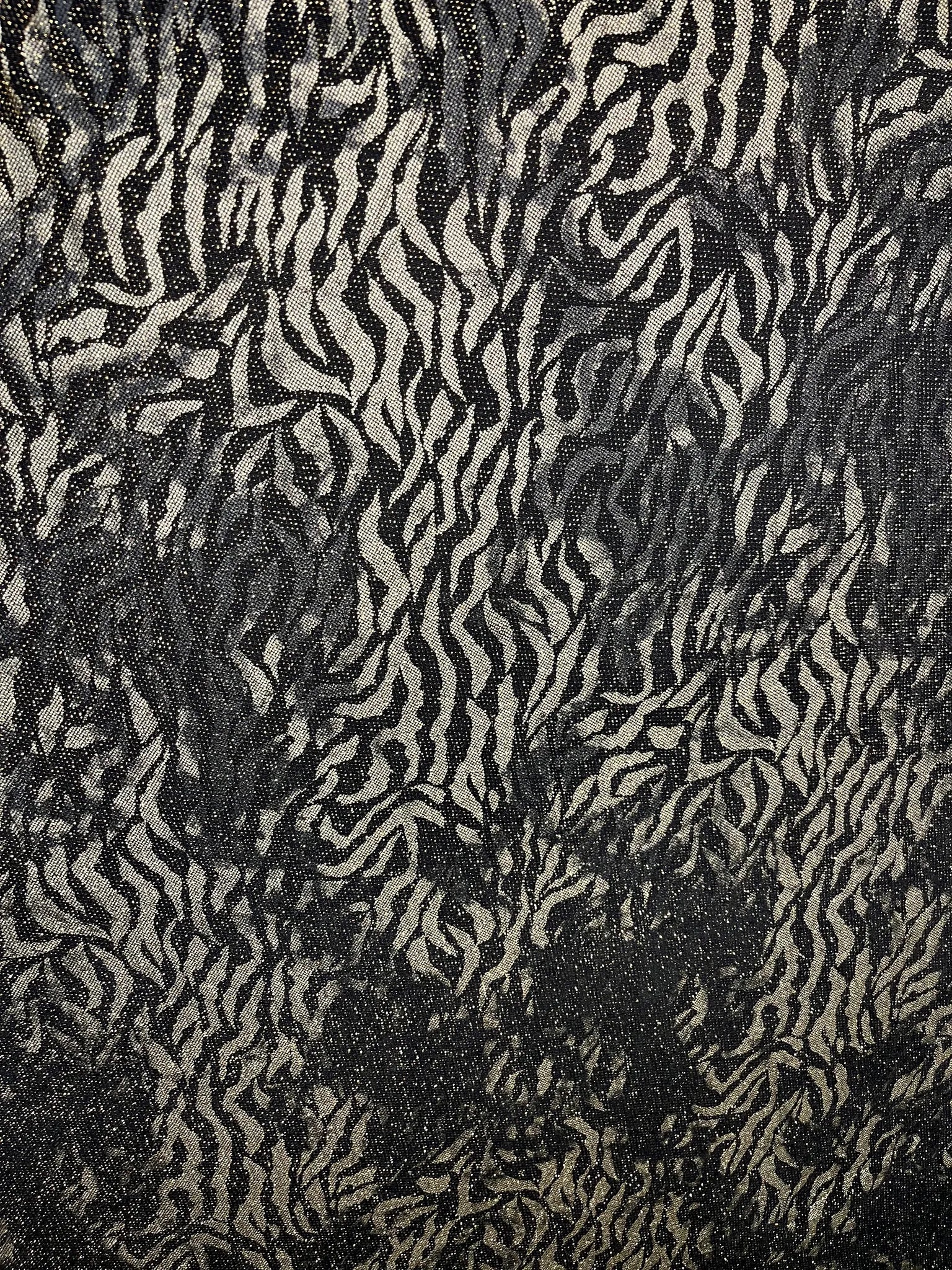 Black and gold zebra print Lurex fabric draped elegantly