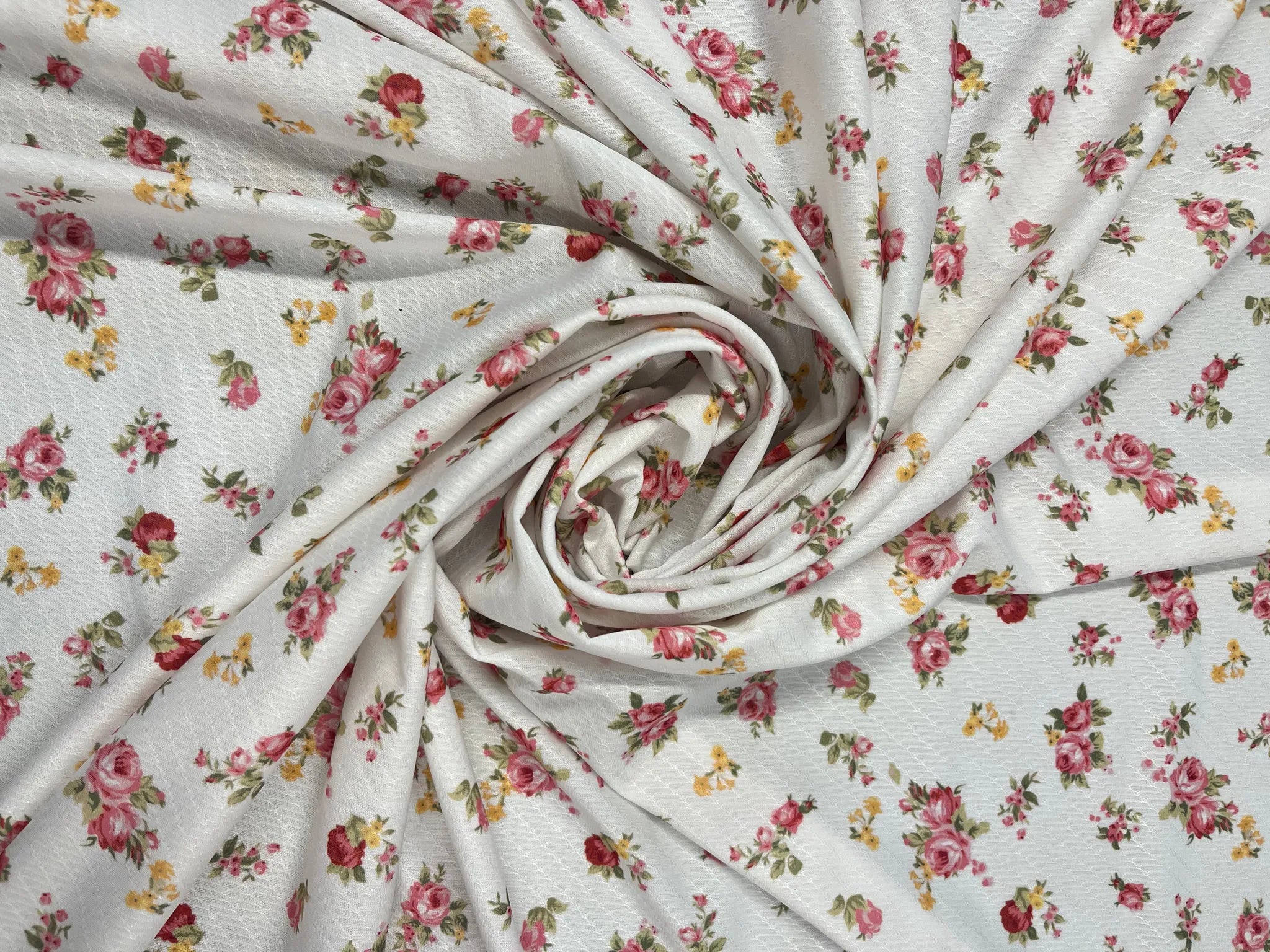 Soft white floral fabric with pink roses detail
