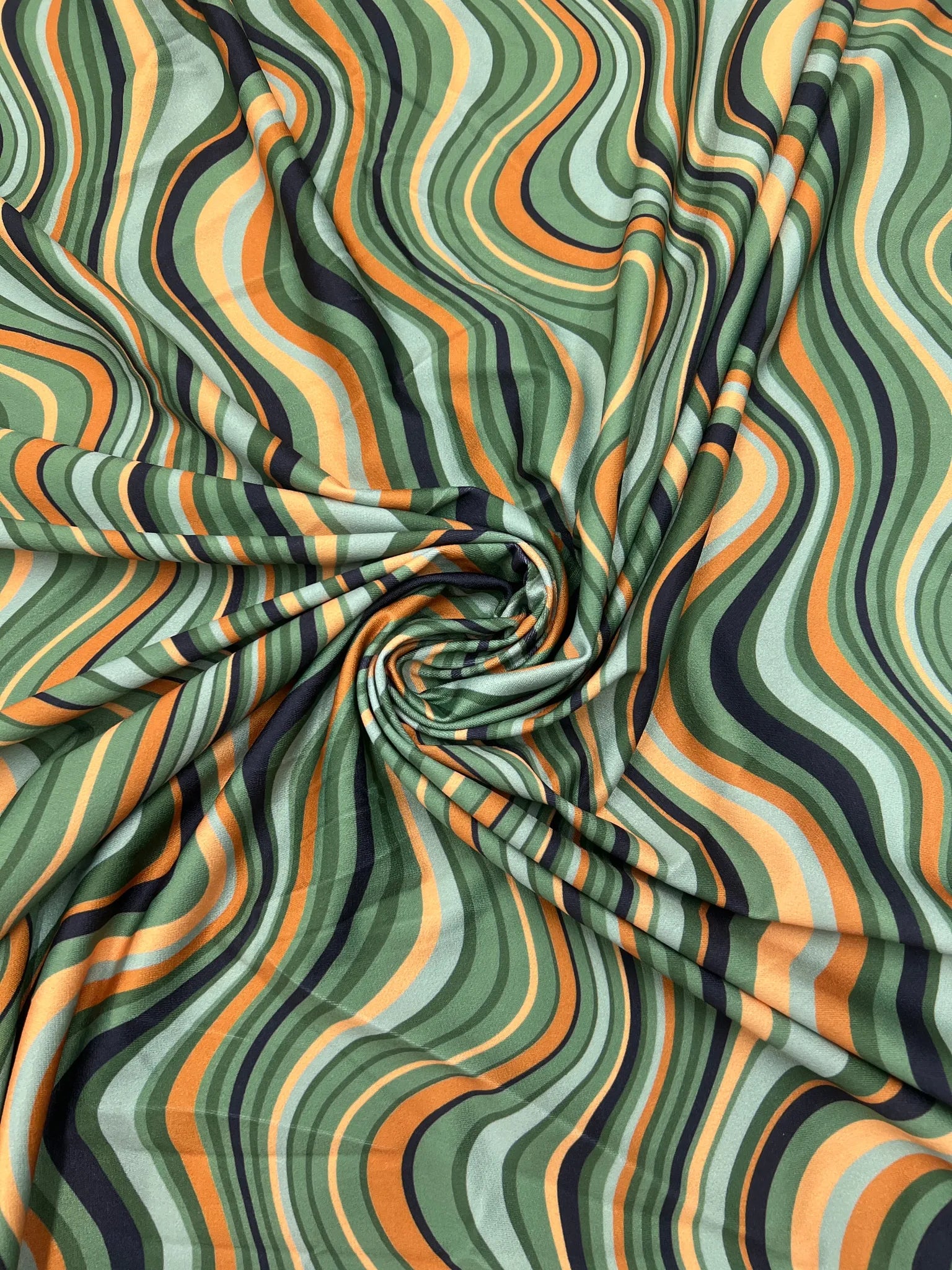 Green, Orange, and Black Swirl Jersey Crepe Fabric swatch