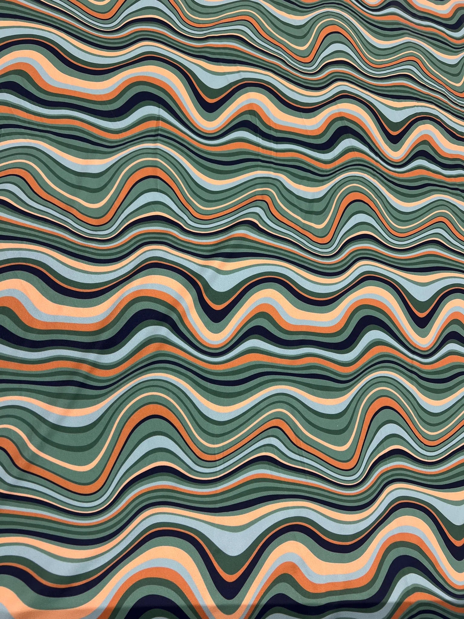 Green Orange Black Swirl Jersey Crepe fabric cut by the meter