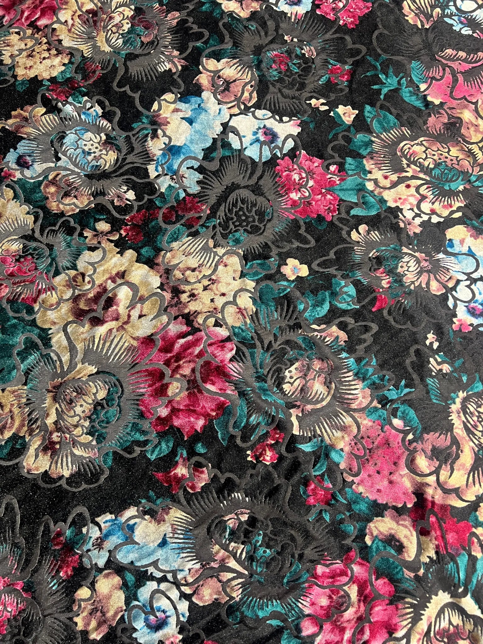 Elegant drape of black floral embossed velvet fabric