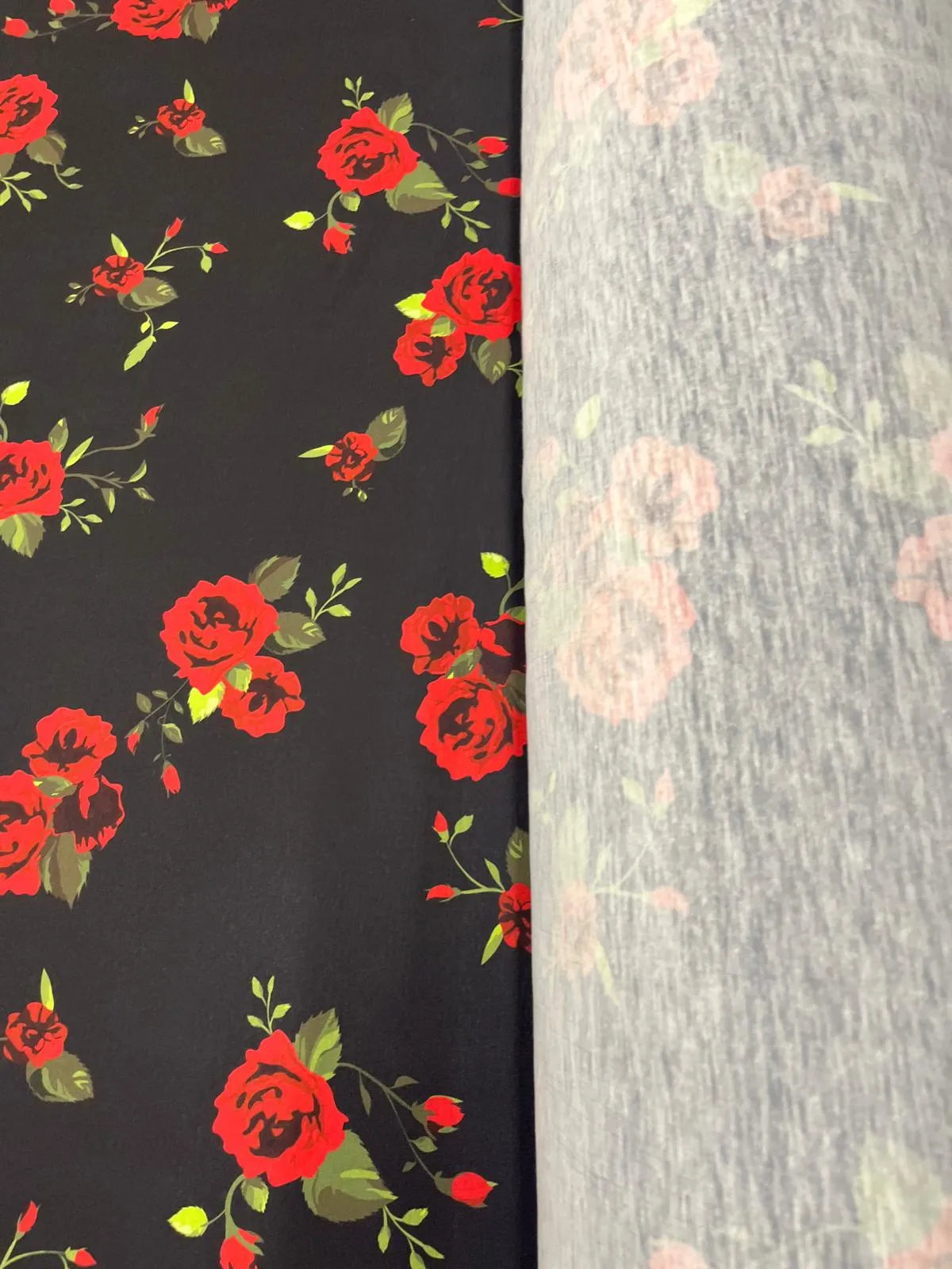 Close-up of black and red floral print on jersey fabric.