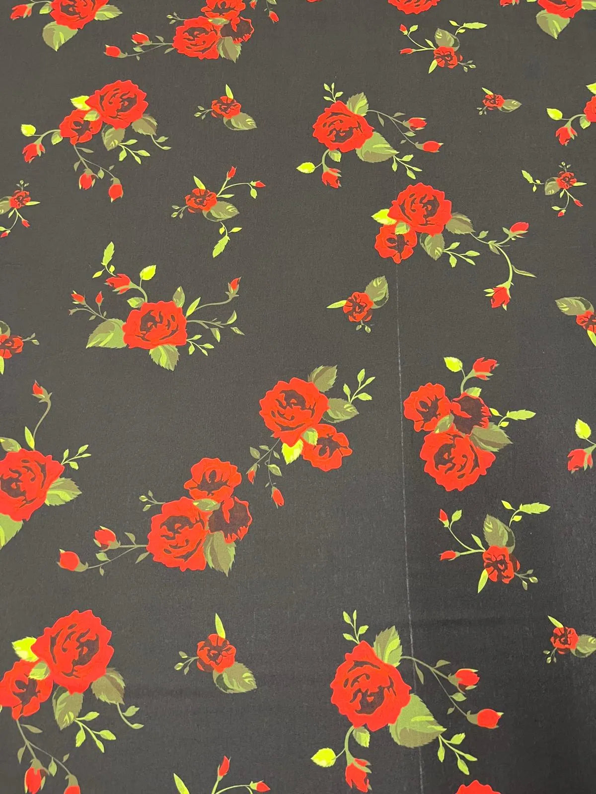 Flowing black and red rose floral jersey fabric draped.