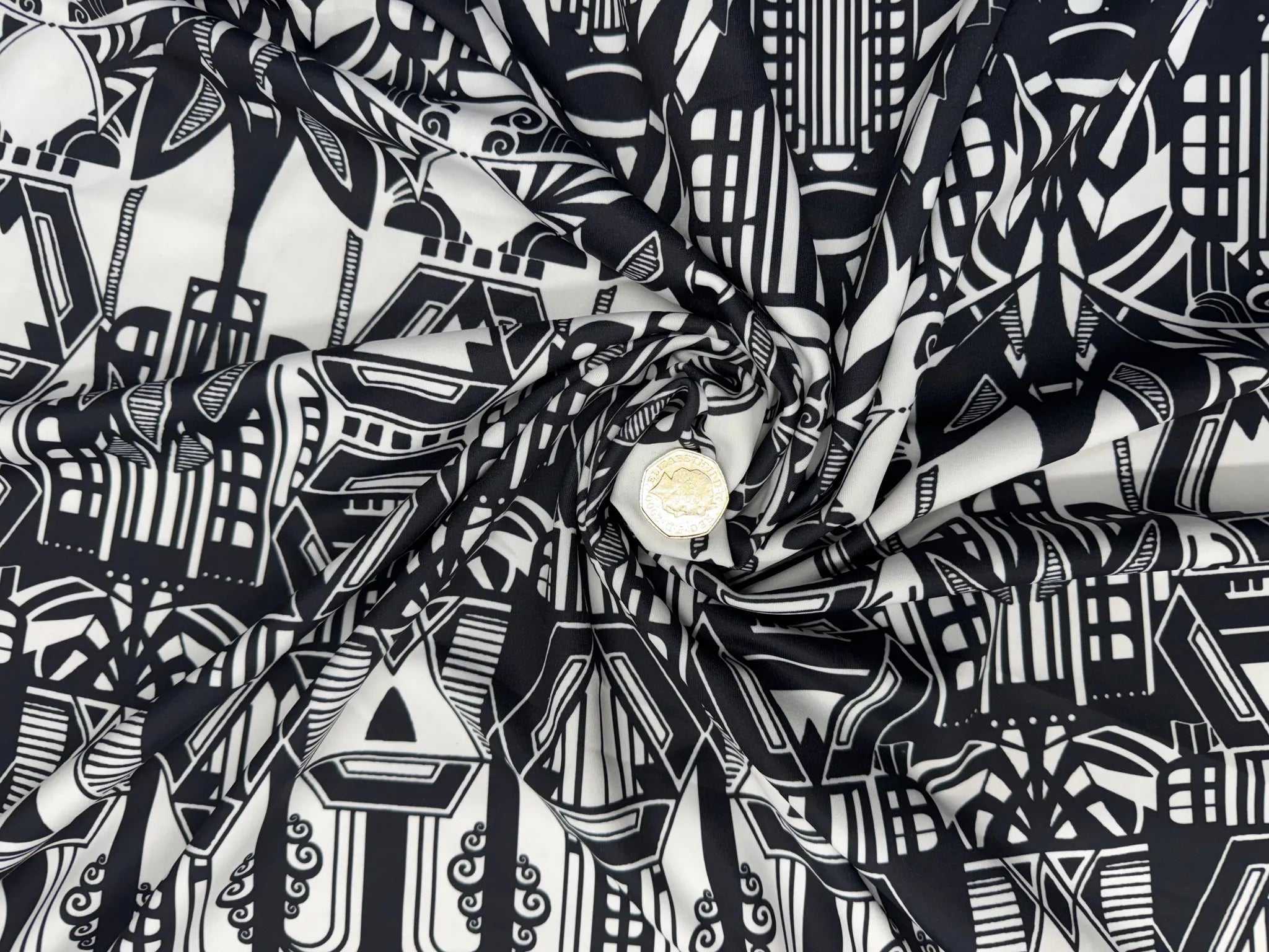 Art Deco black and white geometric print fabric on display.