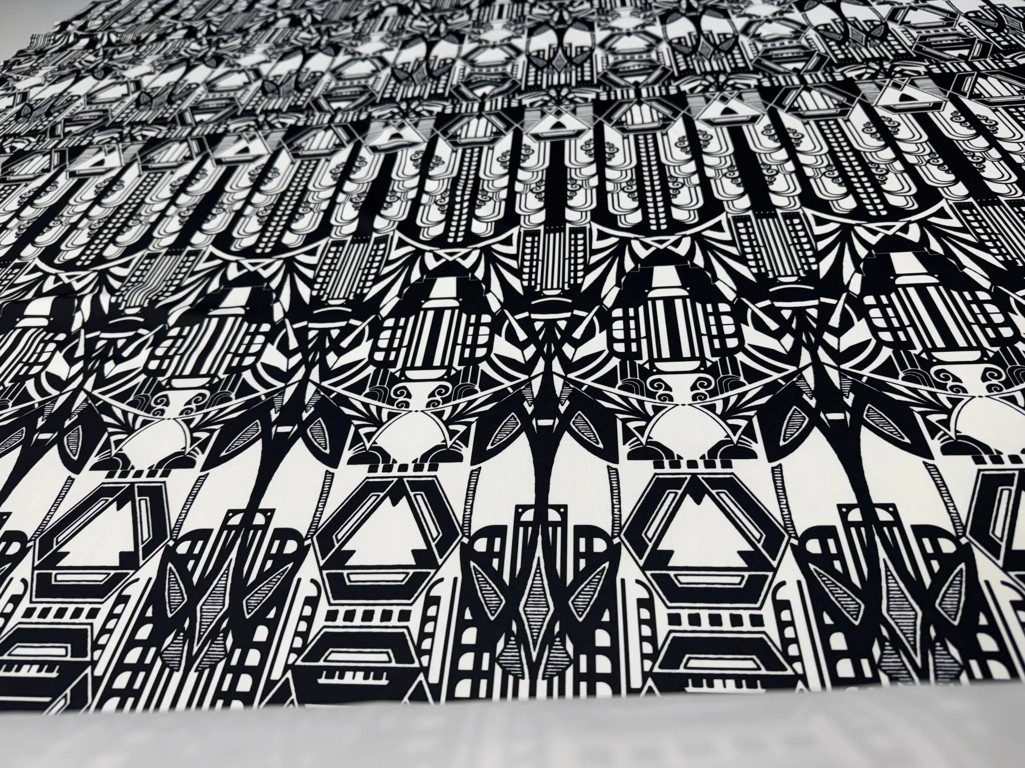 Lightweight jacket made from black and white geometric fabric.