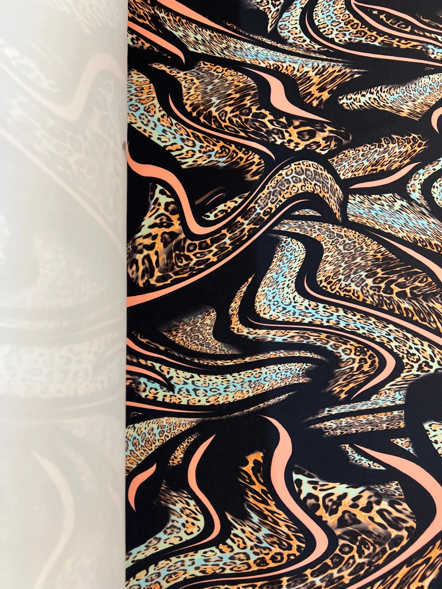 Roll of leopard print scuba fabric ready for dressmaking