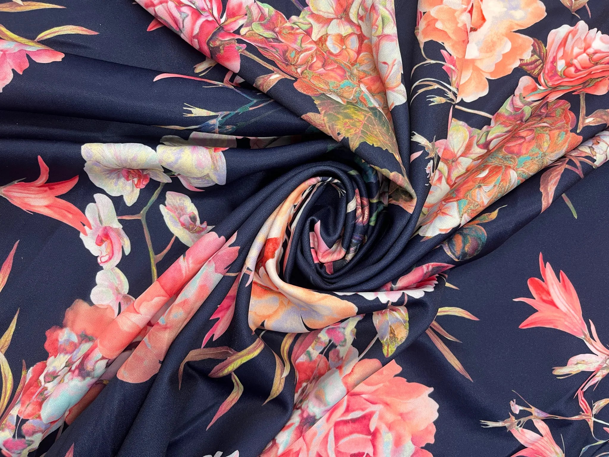 Navy floral stretch fabric with coral and blush blooms