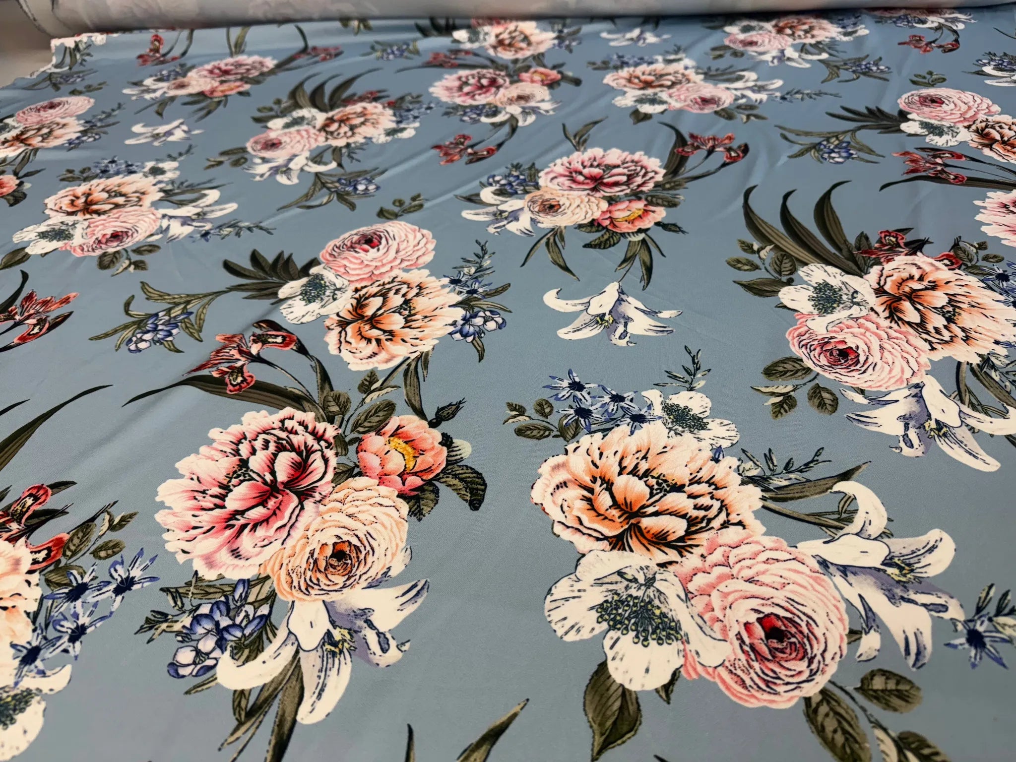 Elegant floral print on dusty blue scuba fabric