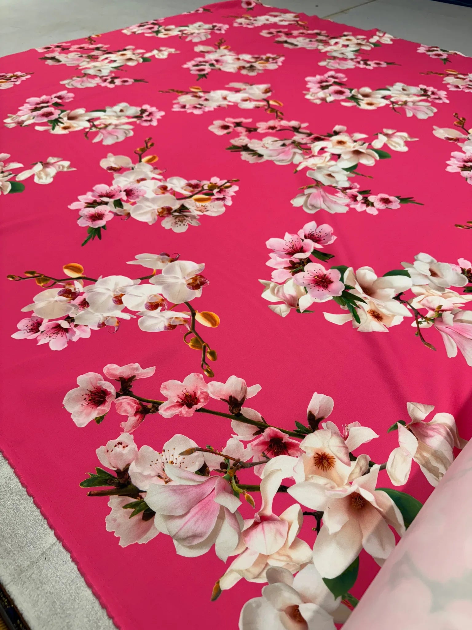 Close-up of vibrant hot pink floral fabric with orchid prints