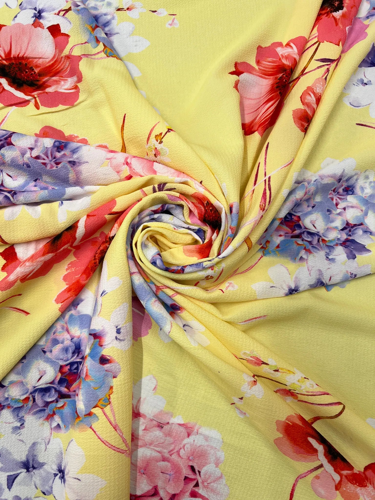 Vibrant yellow floral bubble crepe fabric close-up