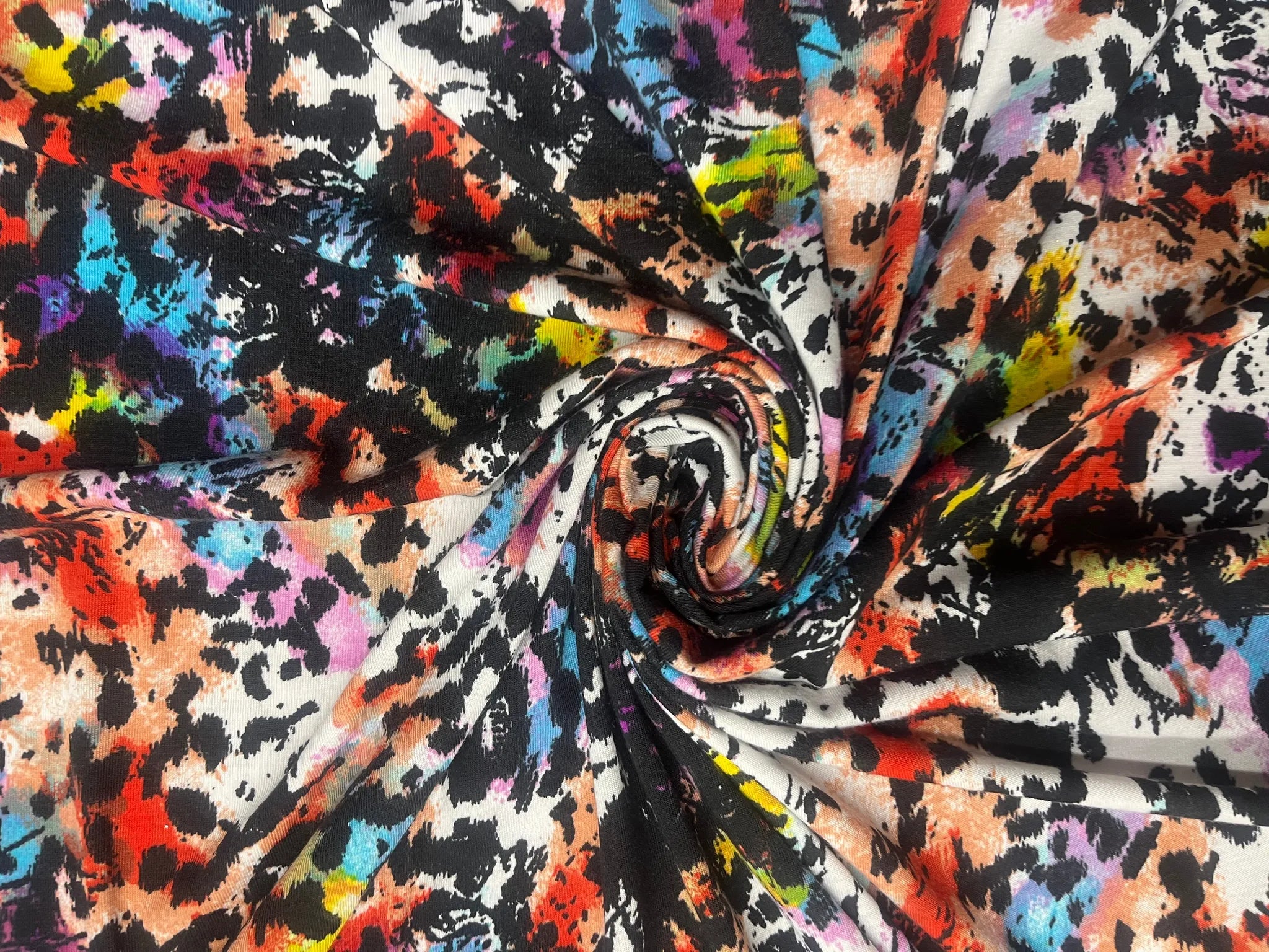 Vibrant multicolor abstract animal print jersey fabric swatch