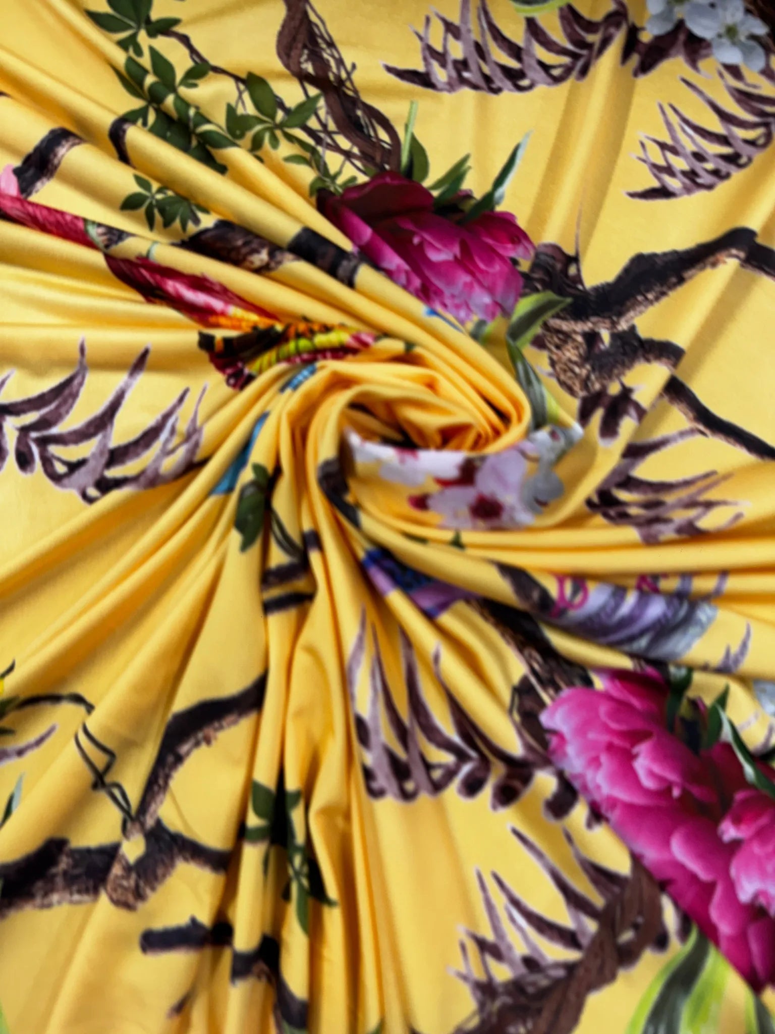 Vibrant yellow slinky jersey fabric with bird and blossom print