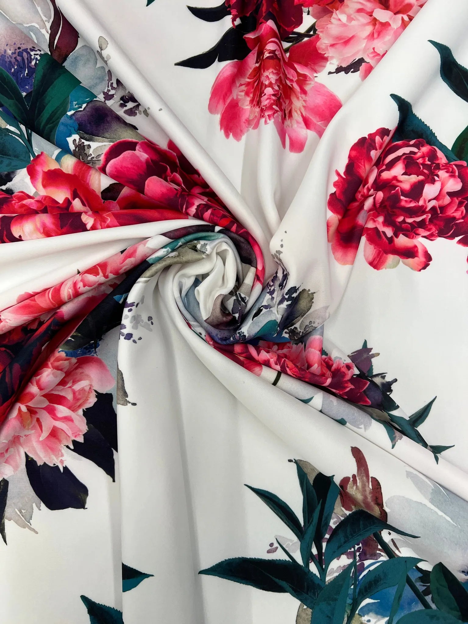 White floral stretch fabric with red and pink peony print