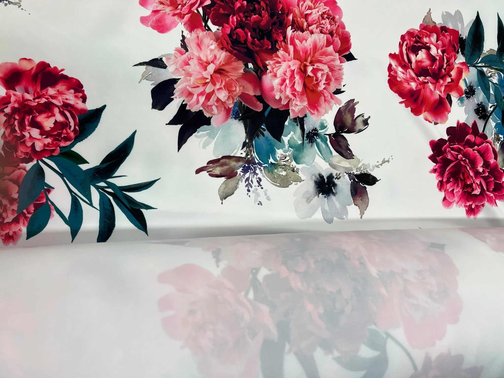 Close-up of peony print on white stretch fabric