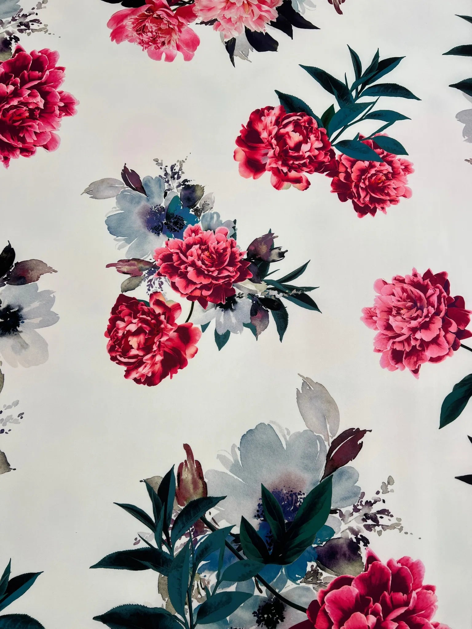 Soft drape of white floral stretch fabric