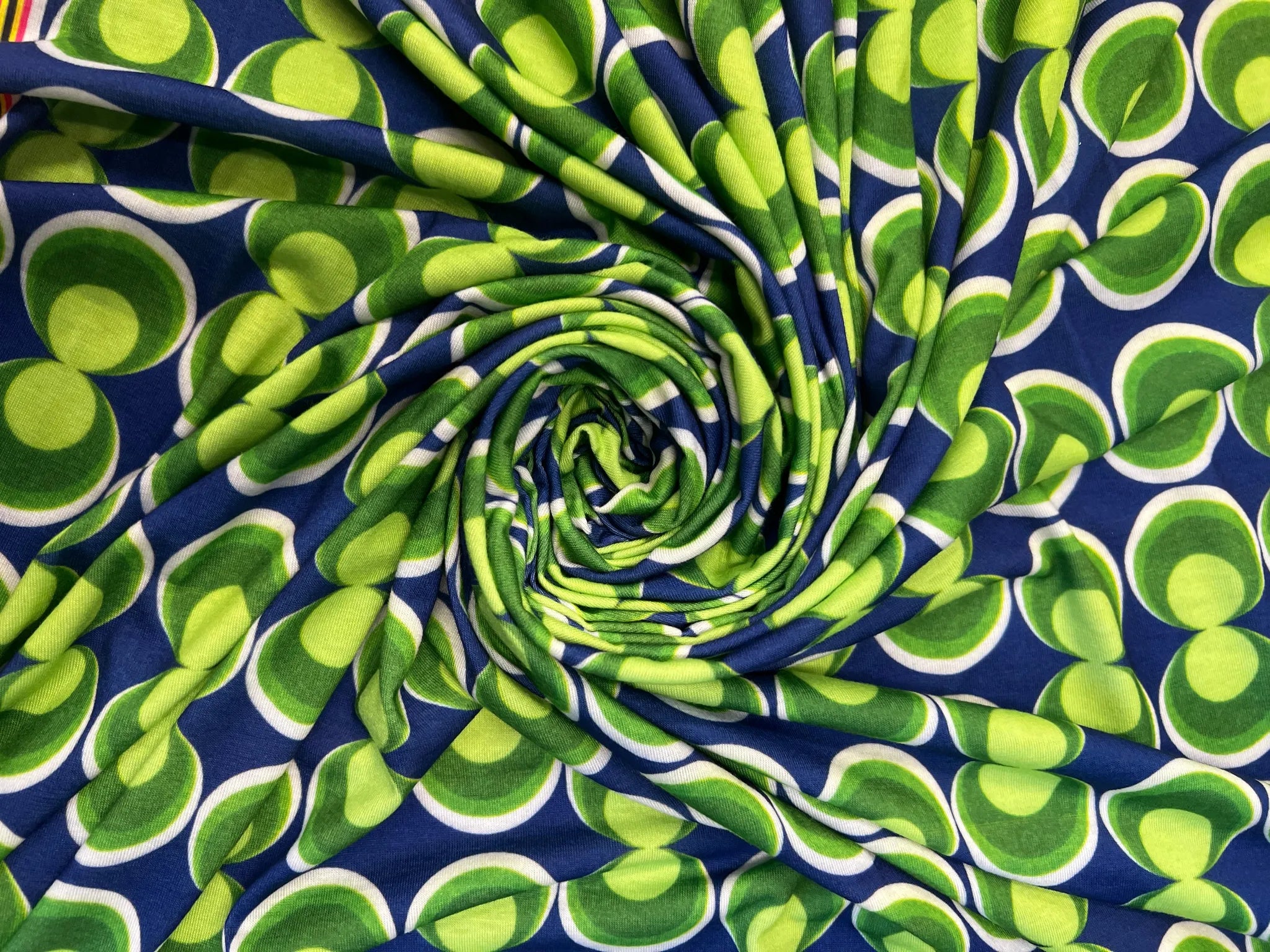 Vibrant blue and green geometric spun polyester fabric