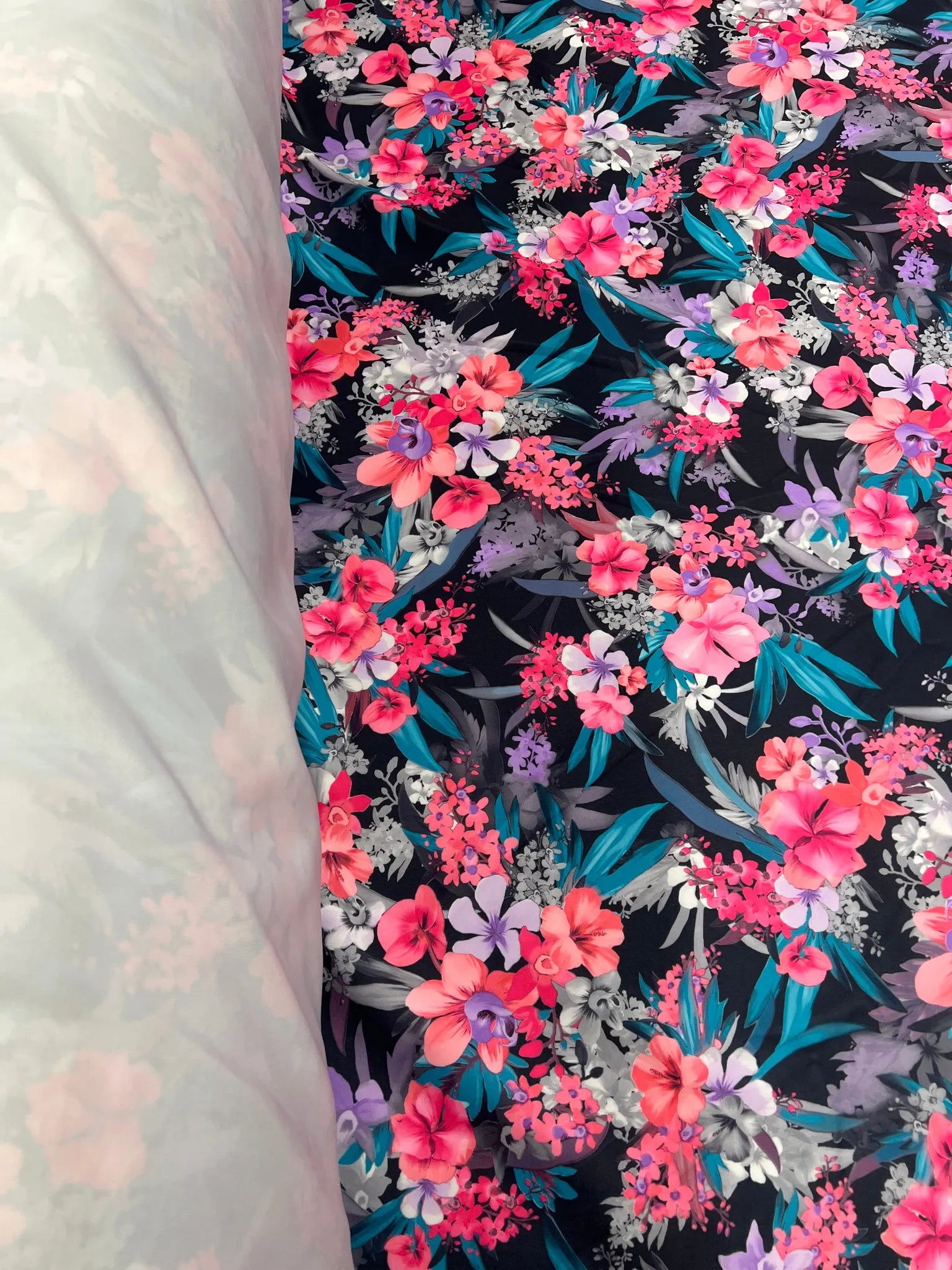 Close-up of vibrant tropical floral print on scuba knit