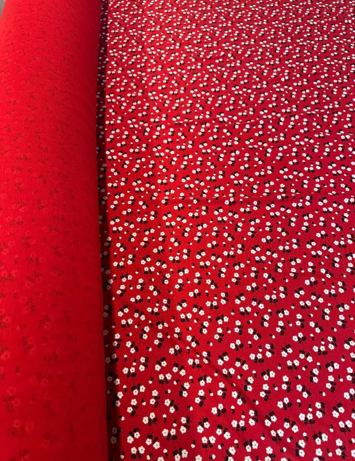 Close-up of red and white floral print viscose fabric