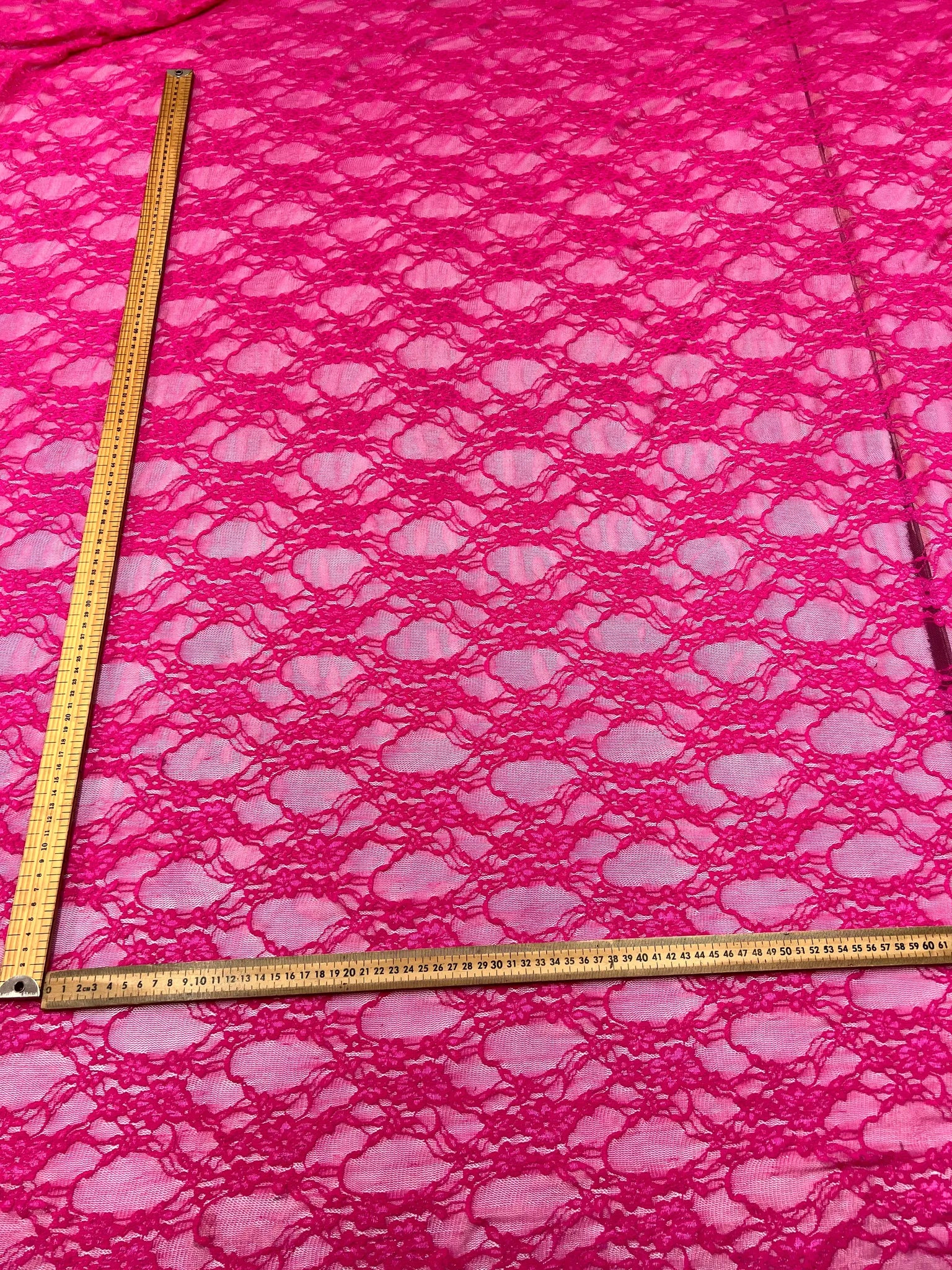 Lightweight sheer hot pink lace fabric for sewing projects