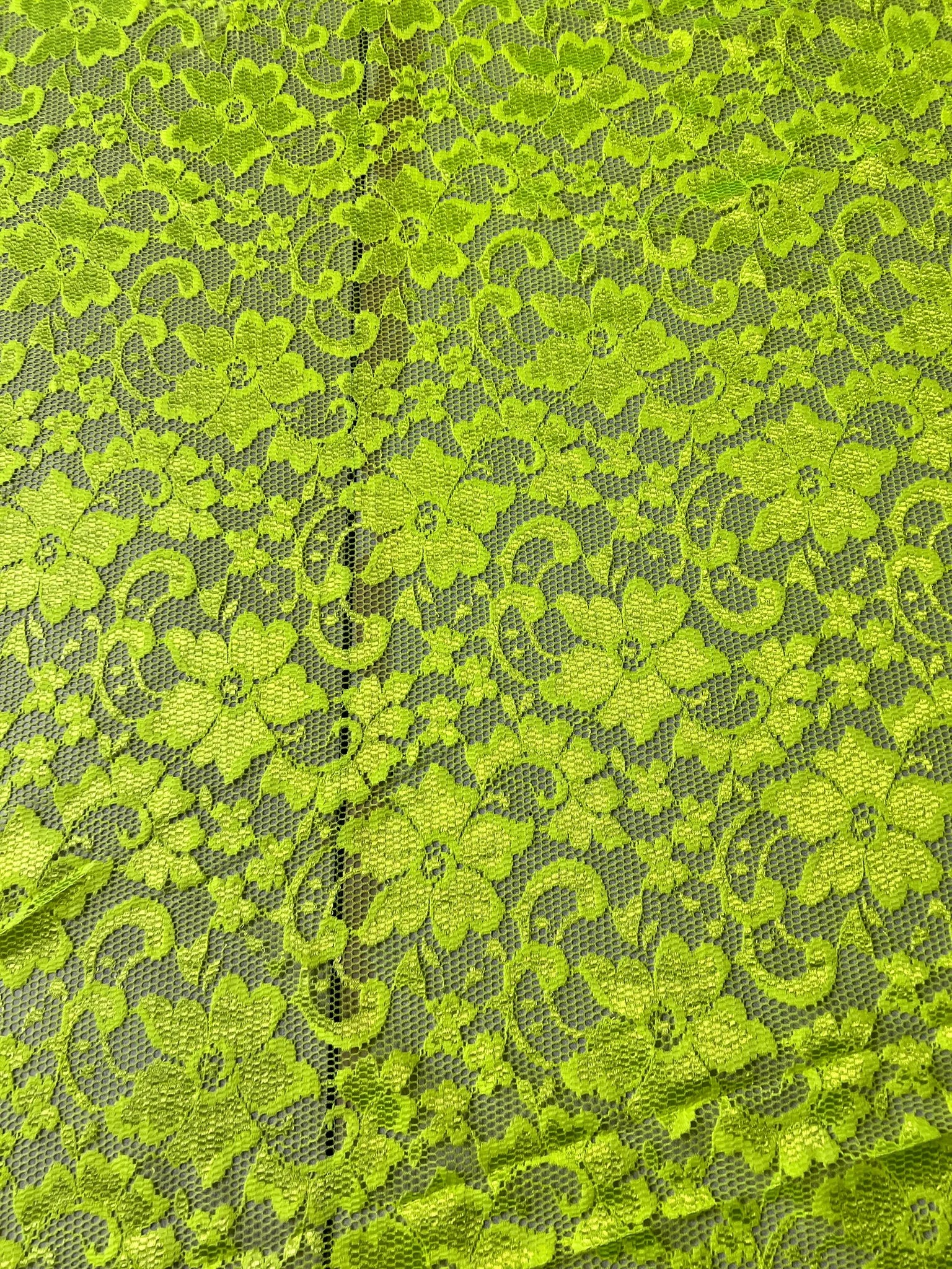 Lightweight Lime Green lace fabric laying flat