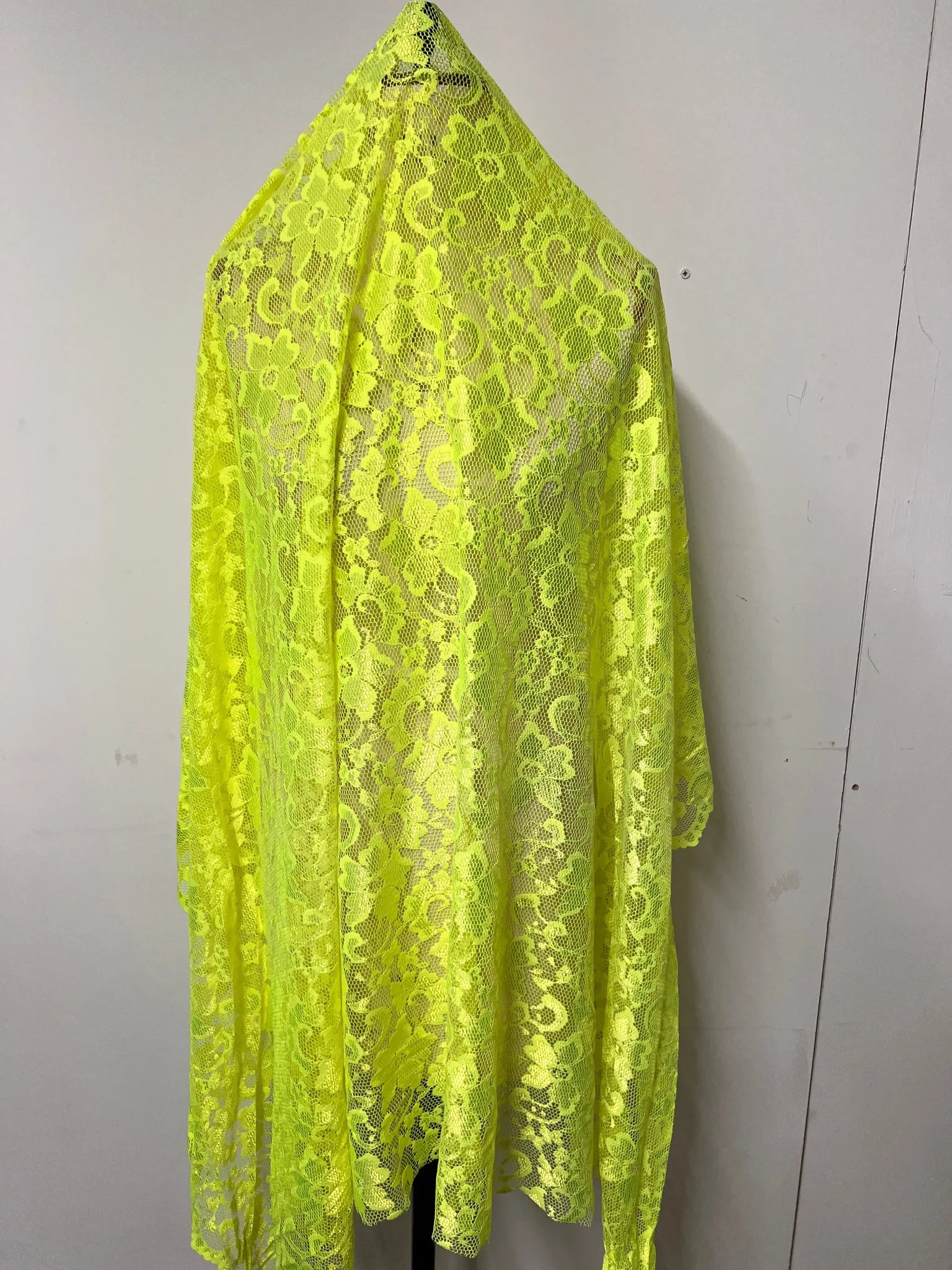 Lime Green lace fabric displayed on a sewing table