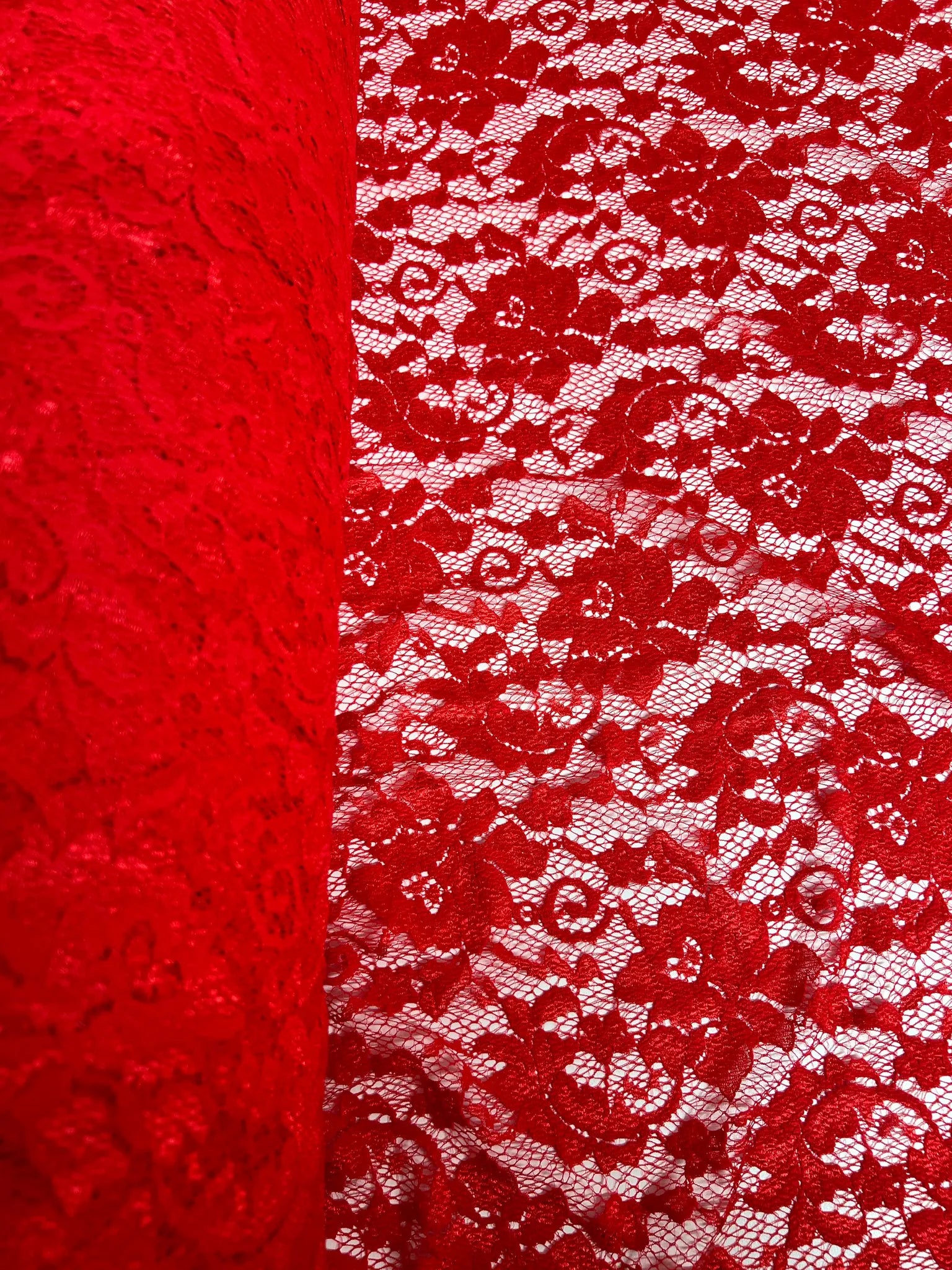 Close-up of red floral lace fabric texture
