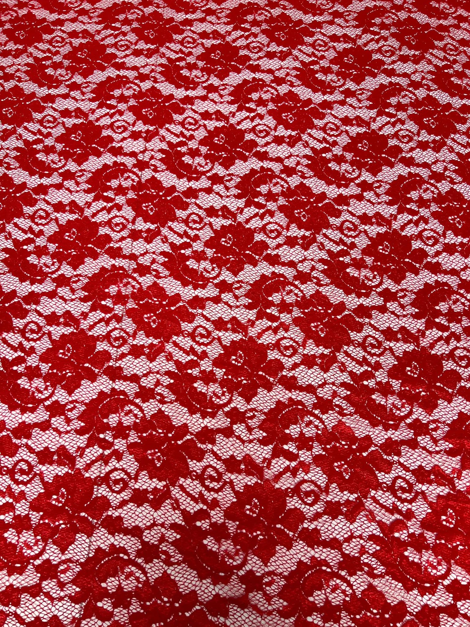 Lightweight red lace fabric draped elegantly