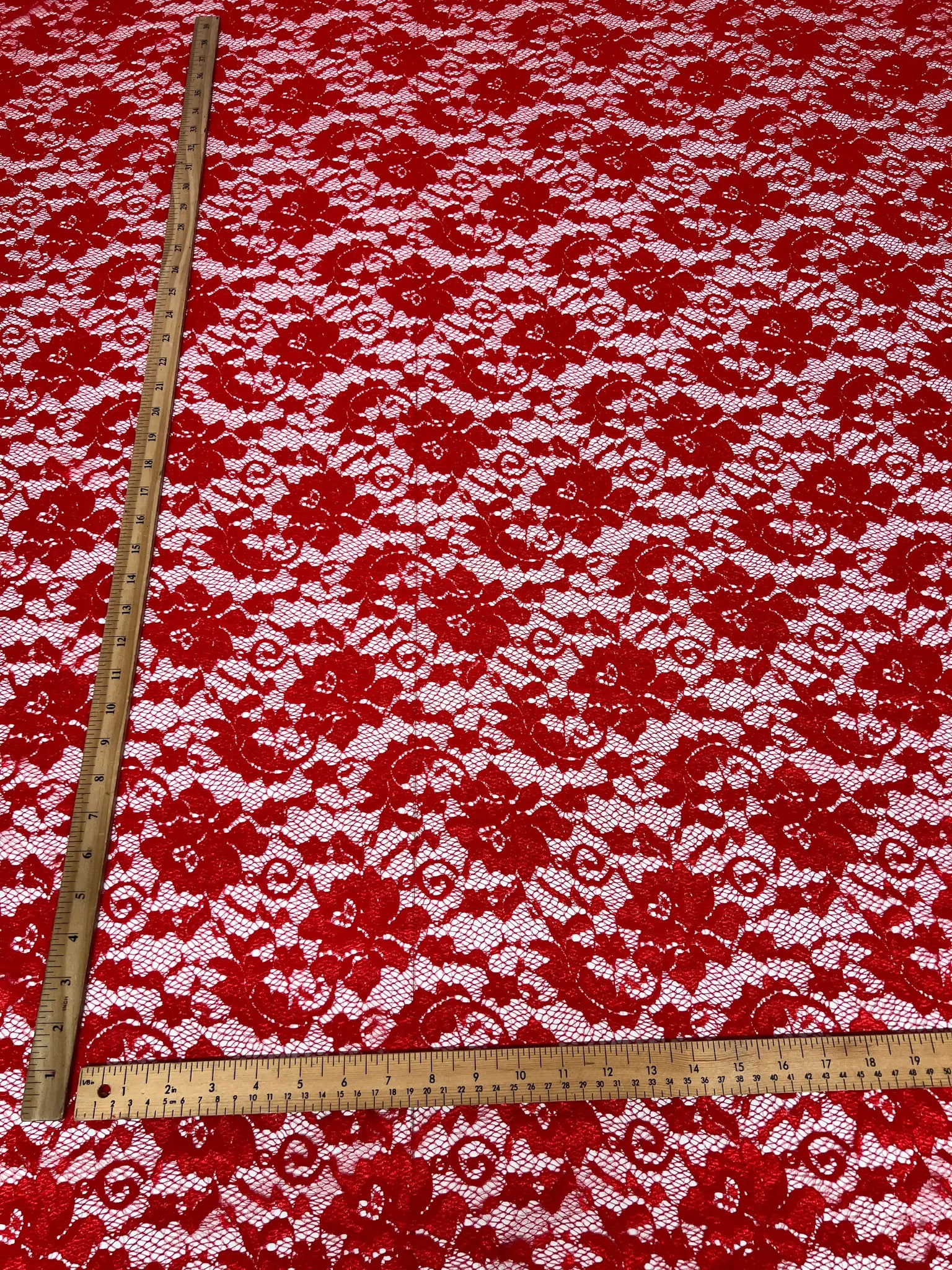 Elegant floral pattern on red lace fabric