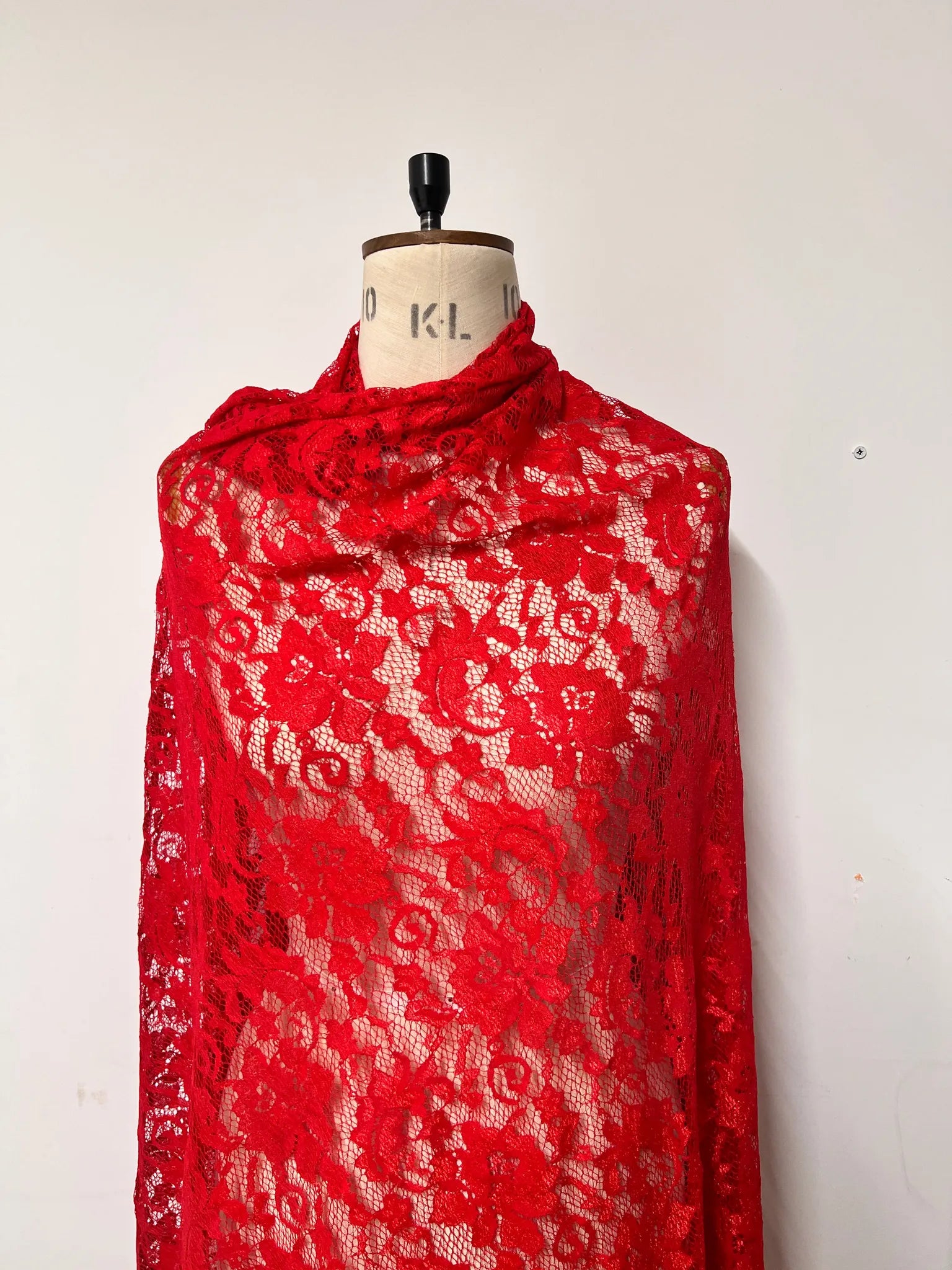 Sewing project with red floral lace fabric