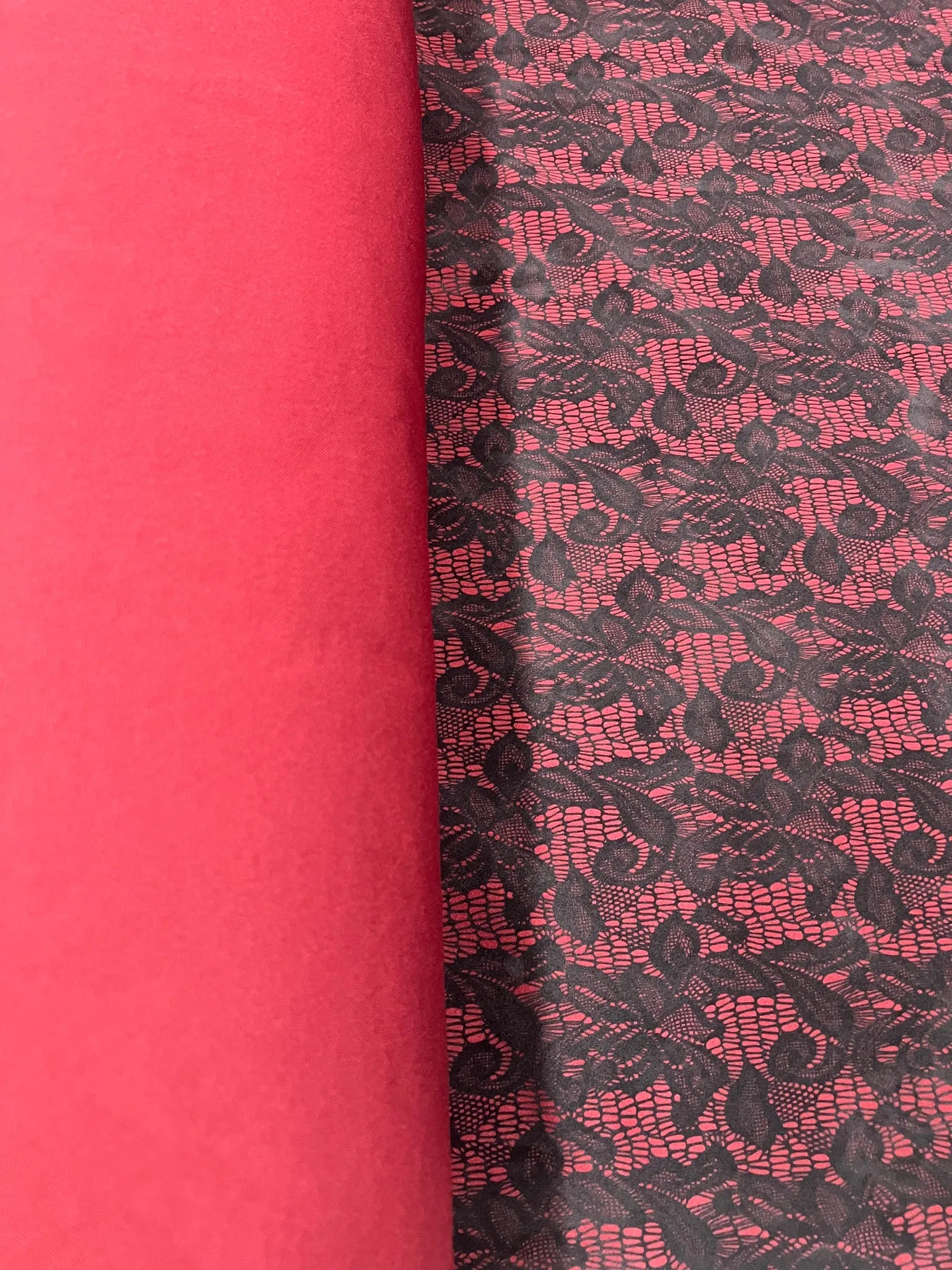 Close-up of red black lace print on jersey knit fabric
