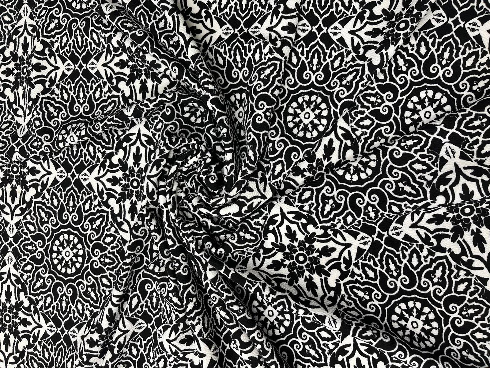 Black and white Liverpool stretch fabric with ornate pattern.