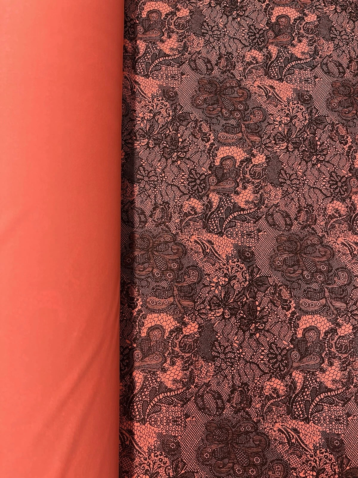 Coral Pink Stretch Lace Fabric with Black Floral Pattern – Elegant & Versatile